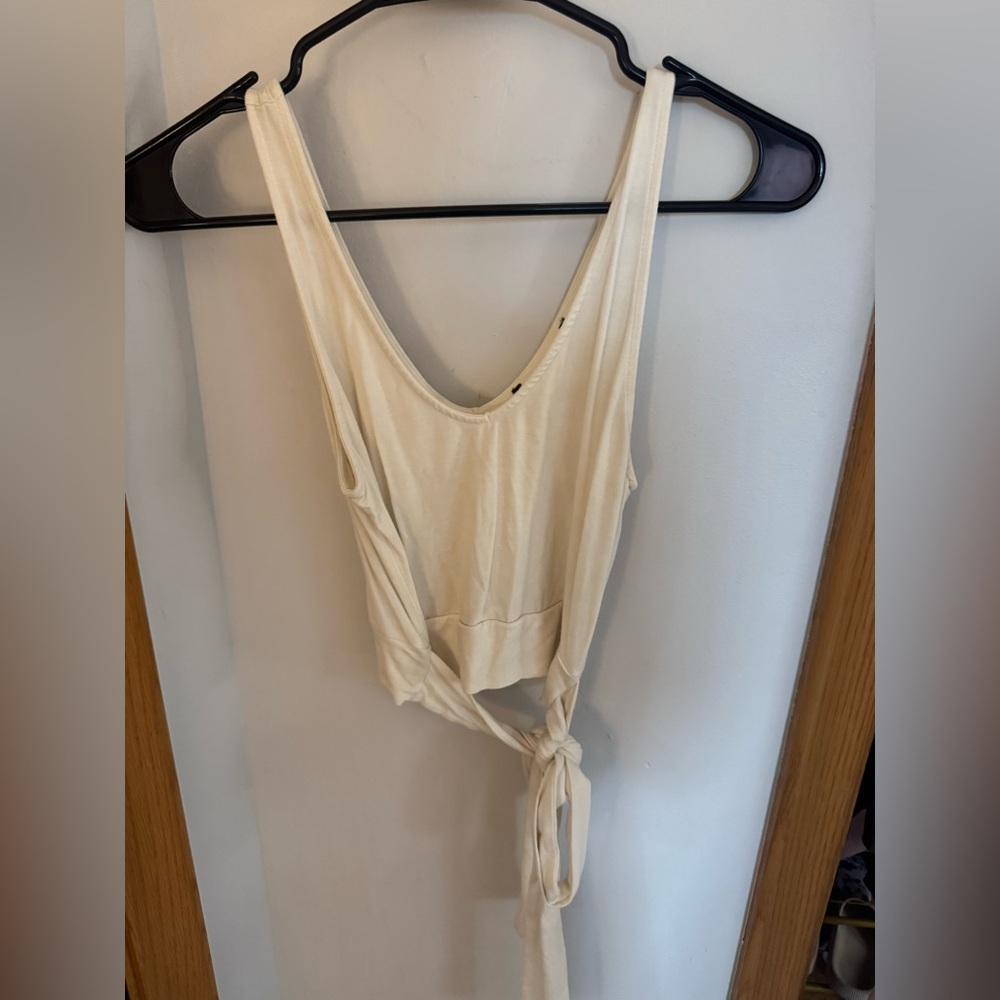 White tank top with strings in back to tie.
